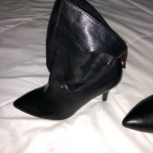 Pointy heeled black leather boots
